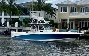 Boston Whaler 370 Outrage 2013 Boston Whaler 370 Outrage boat docked near waterfront homes.