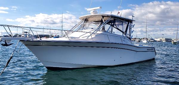 Grady-White Express 330 2007 Grady-White Express 330 boat on water, clear sky, anchored in marina.