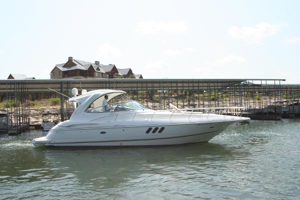 Cruisers Yachts 460 Express 2008 Cruisers Yachts 460 Express on water near dock and buildings.