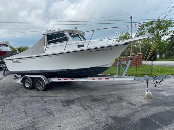 Parker 2120 Sport Cabin 2016 Parker 2120 Sport Cabin boat on trailer, parked outdoors.