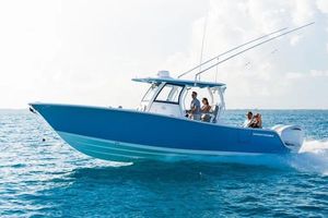 Sportsman Open 302 Center Console 2026 Sportsman Open 302 Center Console boat cruising on clear blue ocean waters.
