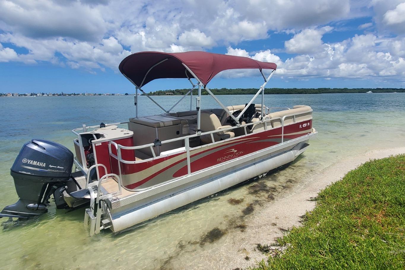 Bennington 22 SSI 2012 Bennington 22 SSI pontoon boat with Yamaha motor on a sandy shore.