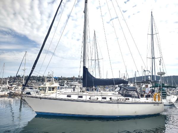 Caliber 38 1989 Caliber 38 sailboat docked in a marina with other boats.