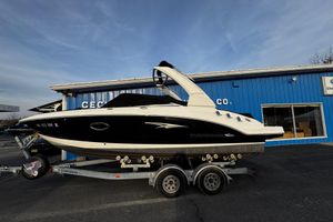 Chaparral 246 SSi 2019 Chaparral 246 SSi boat on trailer, parked outside a blue building.