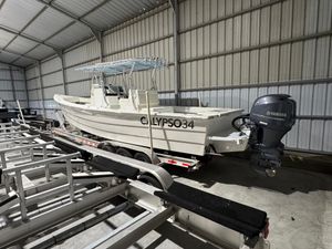 Calypso Center console 2023 Calypso Center Console boat in storage, featuring Yamaha outboard motor.