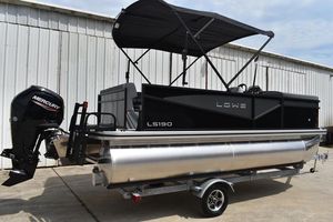 Lowe LS 190 2026 Lowe LS 190 pontoon boat with Mercury outboard motor, parked on trailer.