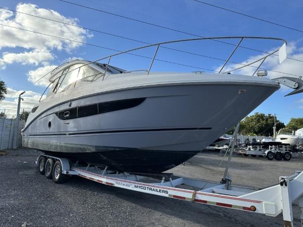 Sea Ray Sundancer 350 Coupe 2017 Sea Ray Sundancer 350 Coupe on trailer under blue sky.