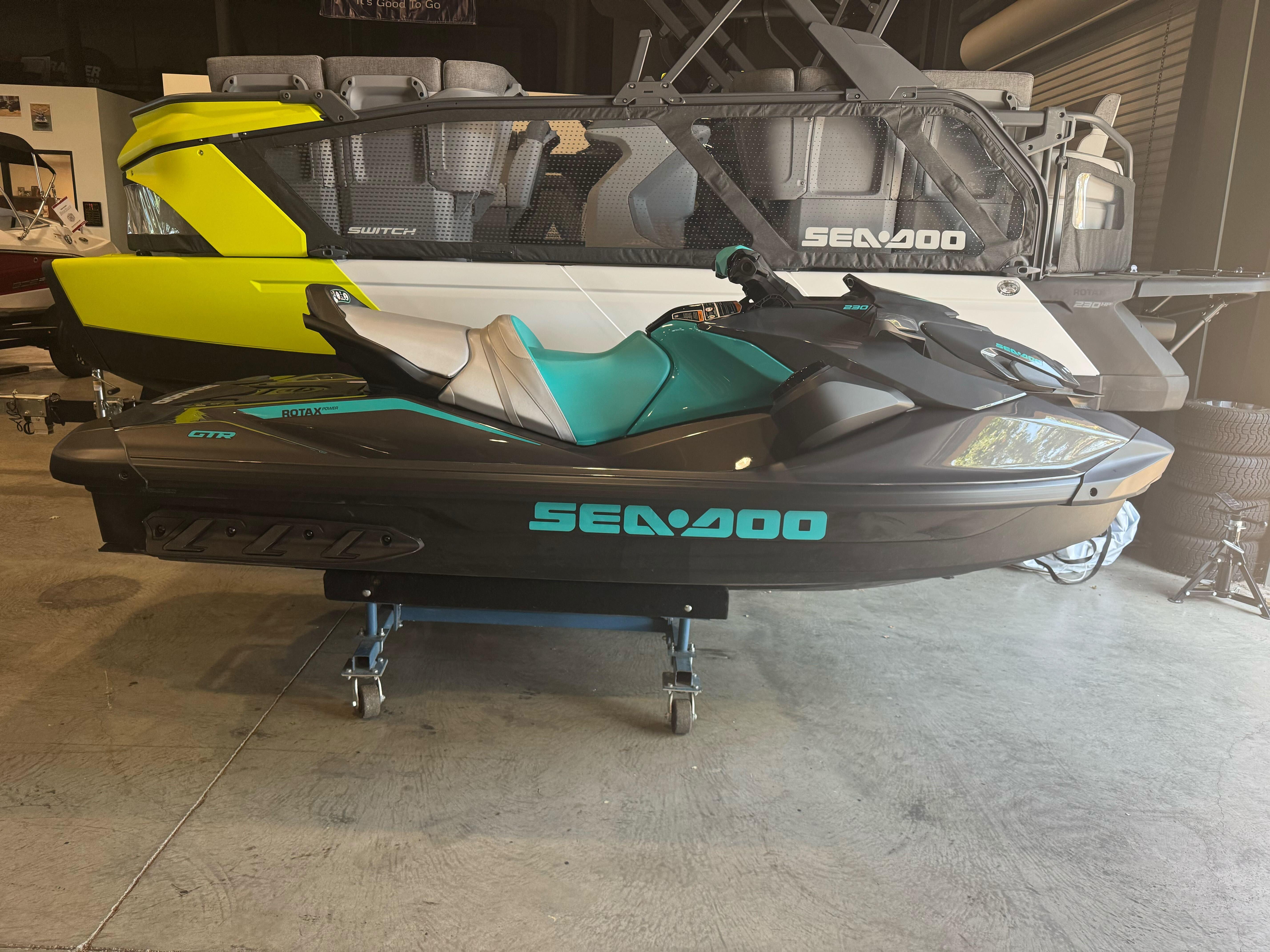 Sea-Doo GTR 230 2025 Sea-Doo GTR 230 jet ski displayed indoors, featuring sleek design and vibrant colors.