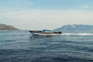 Goldfish 46 Open 2025 Goldfish 46 Open boat cruising on calm sea with scenic mountain backdrop.