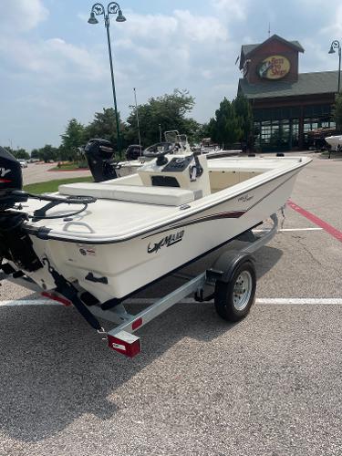 Mako Pro Skiff 13 CC 2025 Mako Pro Skiff 13 CC boat on trailer in parking lot.