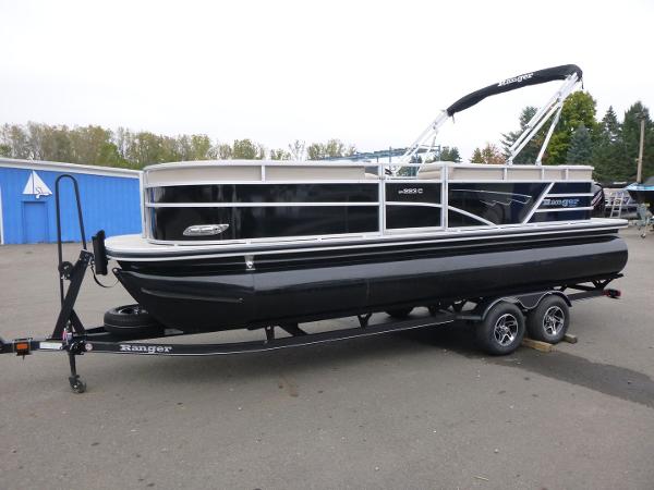 Ranger Reata 223C 2024 Ranger Reata 223C pontoon boat on trailer, parked outdoors.