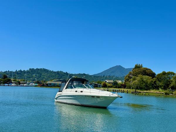 Sea Ray 340 Sundancer 2001 Sea Ray 340 Sundancer yacht on a serene lake with mountain backdrop.