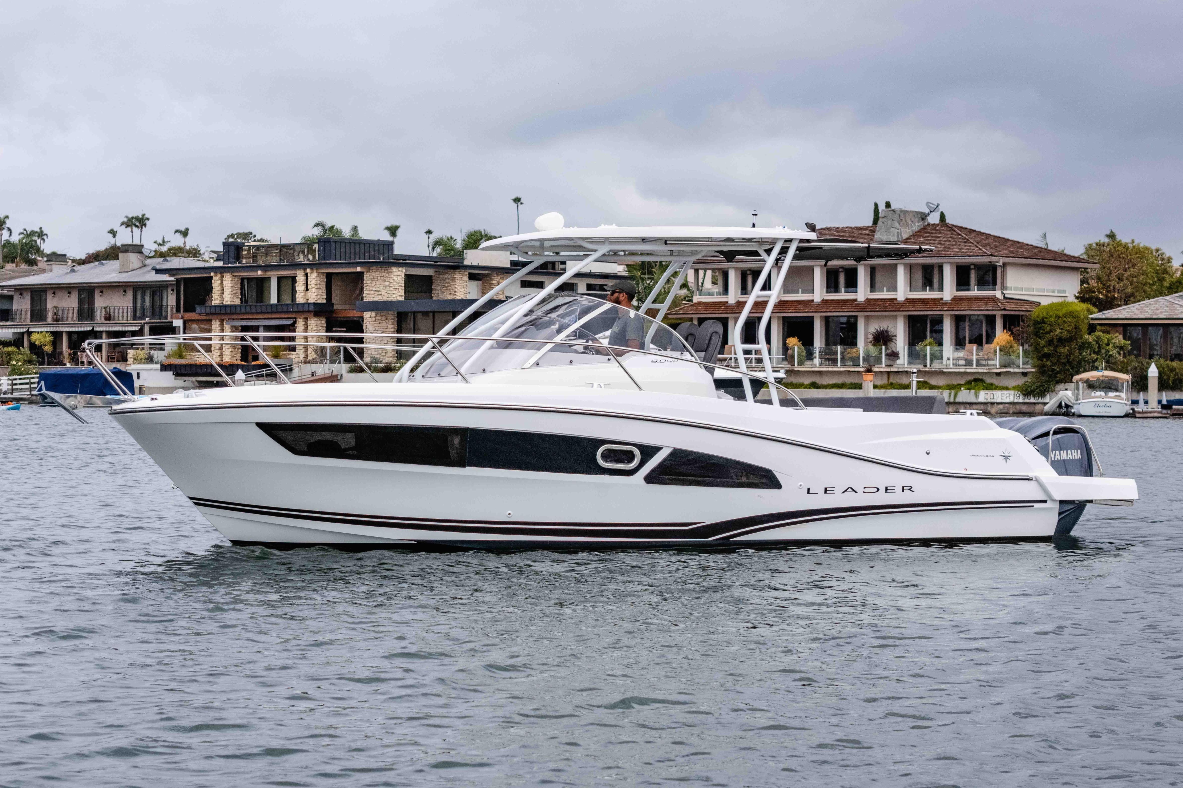 Jeanneau Leader 9.0 WA 2023 Jeanneau Leader 9.0 WA boat on water, with waterfront homes in background.
