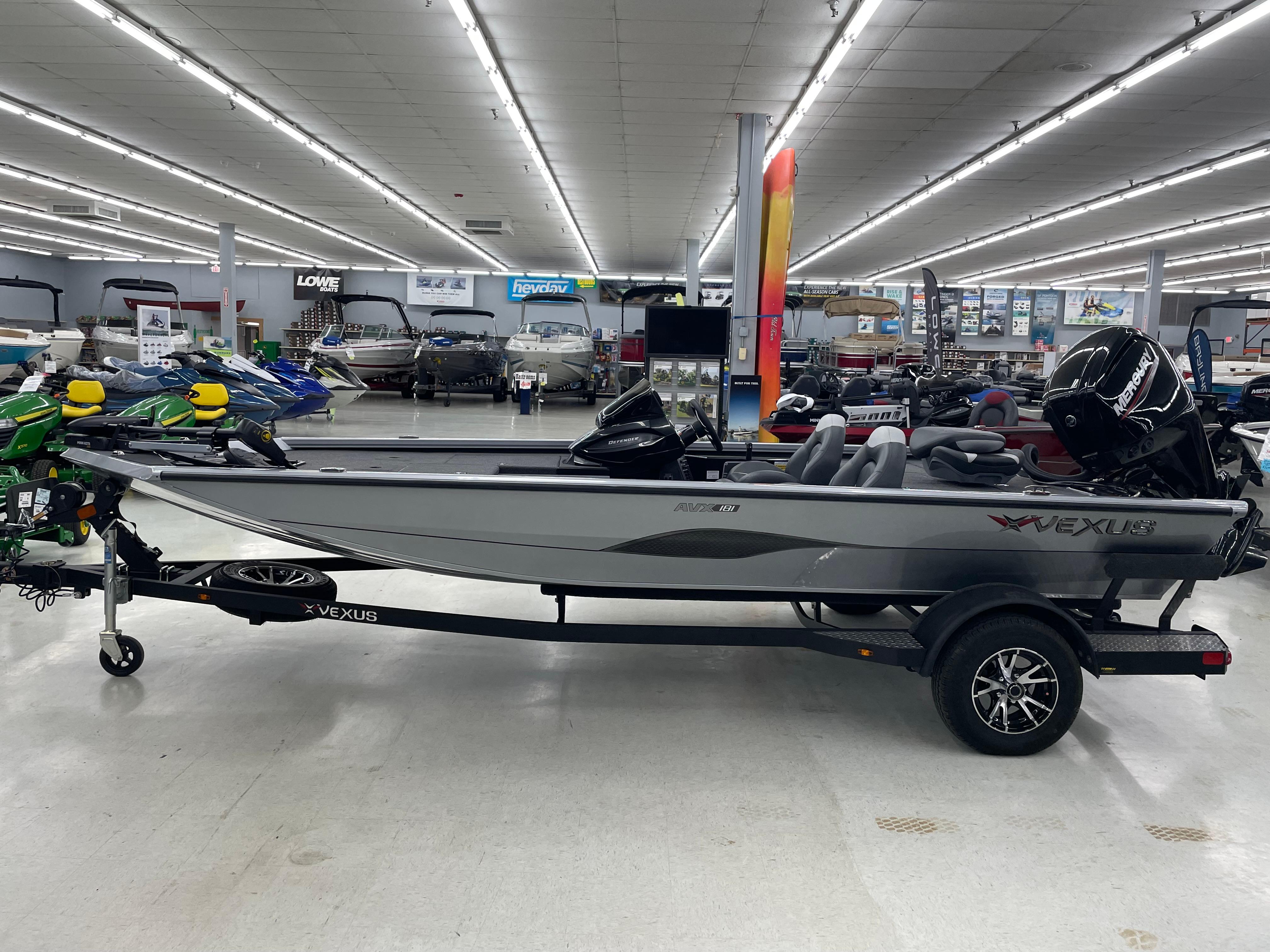 Vexus AVX181 DEFENDER 2025 Vexus AVX181 DEFENDER boat displayed in a showroom with various other boats.