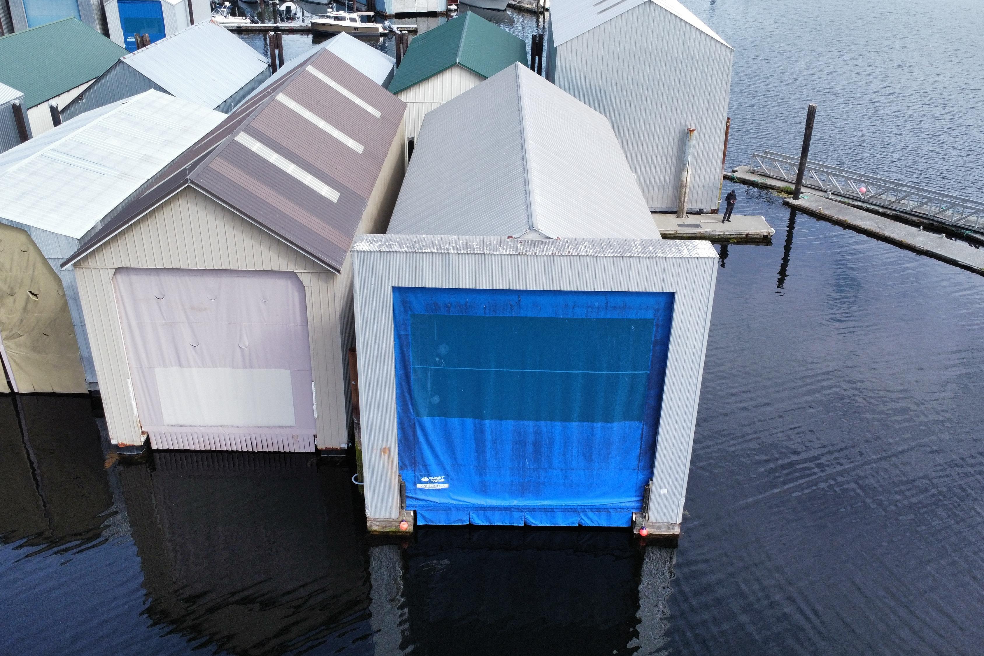 Custom Lynnwood BH Floating boathouses on calm water, featuring a 2007 Custom Lynnwood model.