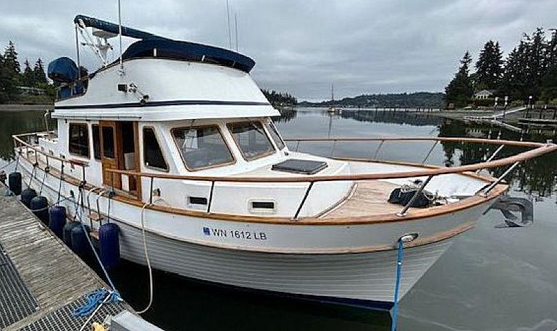 Ocean Double Cabin Trawler 1981 Ocean Double Cabin Trawler docked on a calm lake with overcast skies.