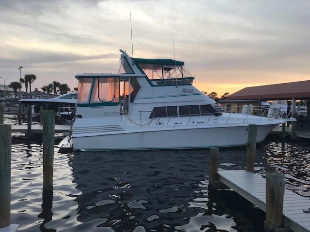 Trojan 12 Meter Motoryacht 1989 Trojan 12 Meter Motoryacht docked at sunset, calm waters, marina setting.