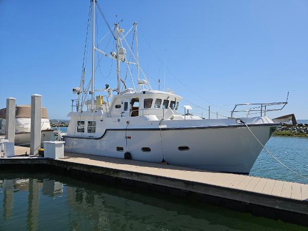 Nordhavn Trawler 2002 Nordhavn Trawler docked at marina under clear blue sky.