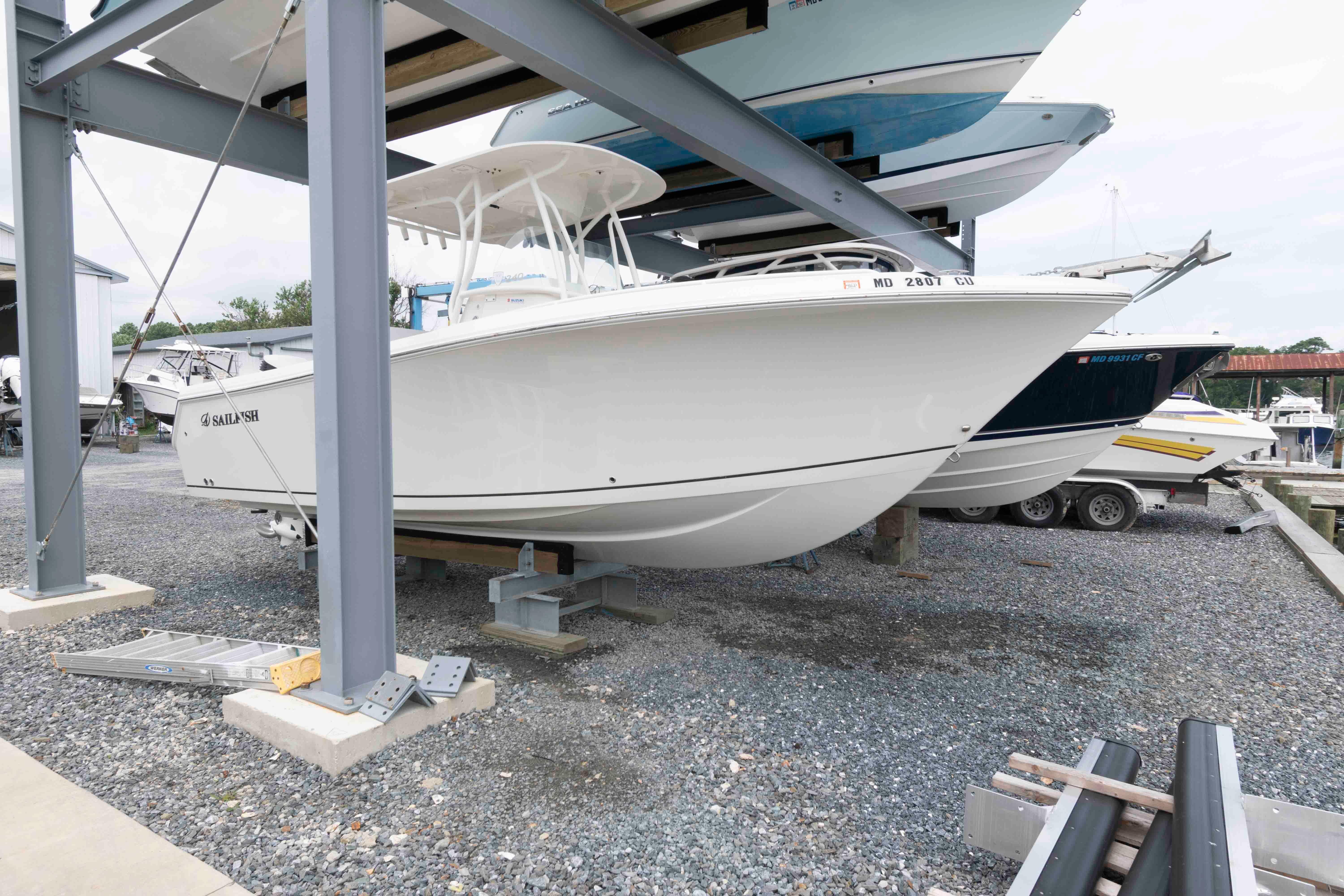 Sailfish 240 CC 2016 Sailfish 240 CC boat stored on a rack in a marina.