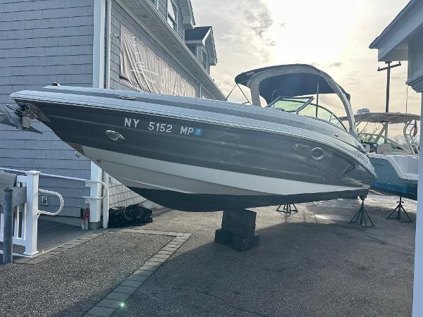 Crownline 290 XSS 2019 Crownline 290 XSS boat displayed on a stand at a marina.