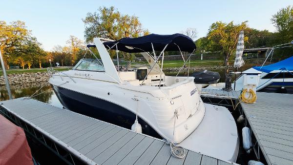Rinker 300 Express Cruiser 2005 Rinker 300 Express Cruiser docked at marina, featuring sleek design and canopy.