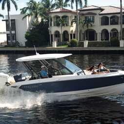 Monterey Elite 27 OB 2026 Monterey Elite 27 OB boat cruising near luxury waterfront homes.