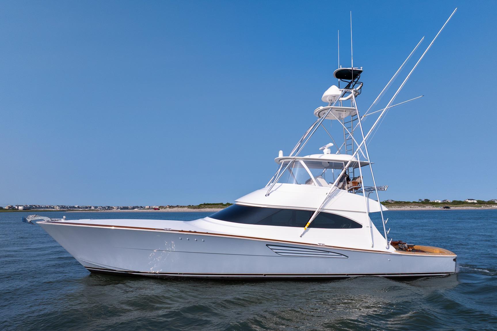 Viking 64 Convertible 2025 Viking 64 Convertible yacht cruising on open water under clear blue sky.