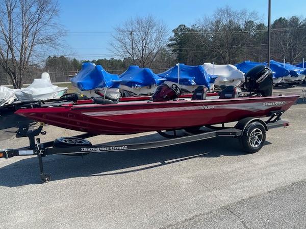 Ranger RT188 2024 Ranger RT188 boat in red on a trailer, parked outdoors.