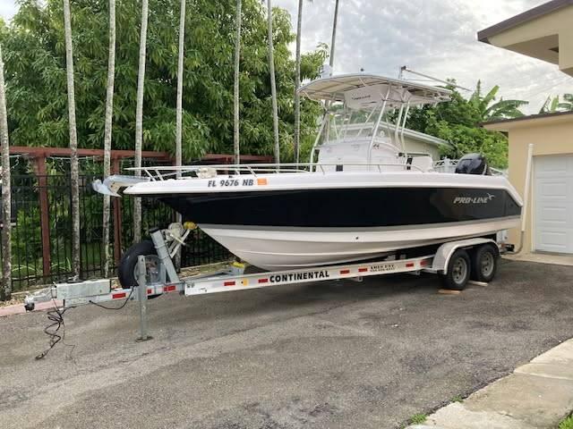 Pro-Line 24 SUPER SPORT 2006 Pro-Line 24 Super Sport boat on trailer, parked outdoors near trees.