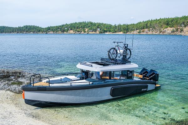 Arksen 30 2025 Arksen 30 boat docked on a scenic shoreline with a bicycle on the roof.