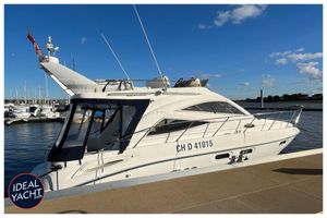 Sealine F34 2007 Sealine F34 yacht docked at marina under clear blue sky.