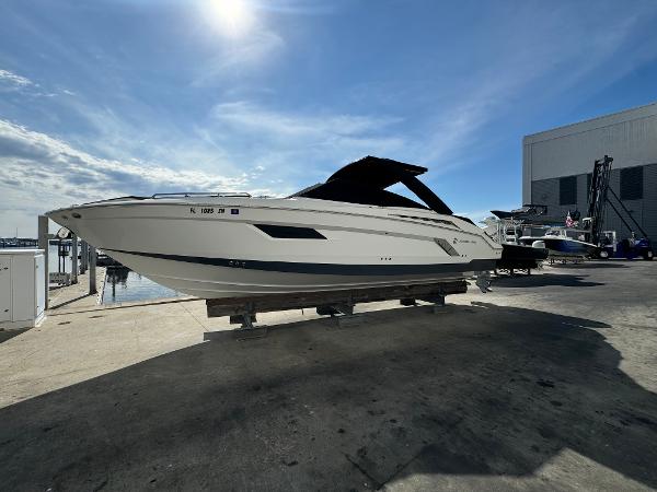 Cruisers Yachts 338 Outboard 2019 Cruisers Yachts 338 Outboard on dry dock under a clear blue sky.