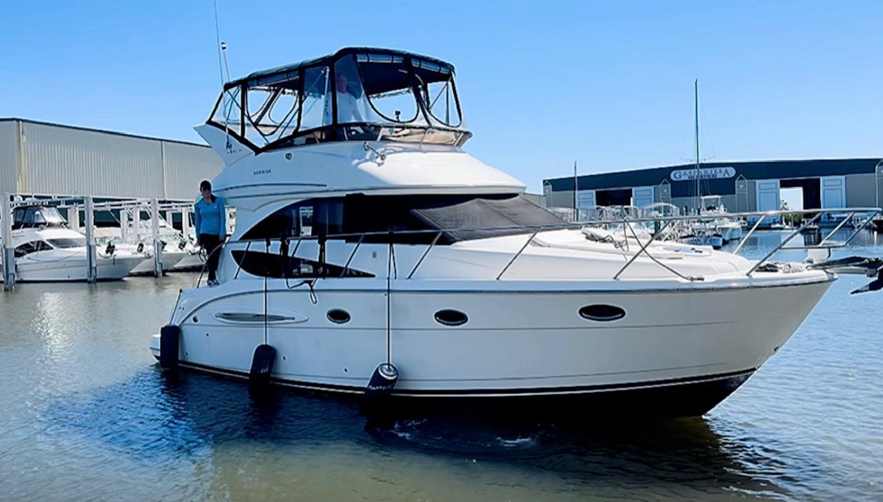 Meridian 341 Sedan 2006 Meridian 341 Sedan yacht docked at marina, clear sky, calm water.