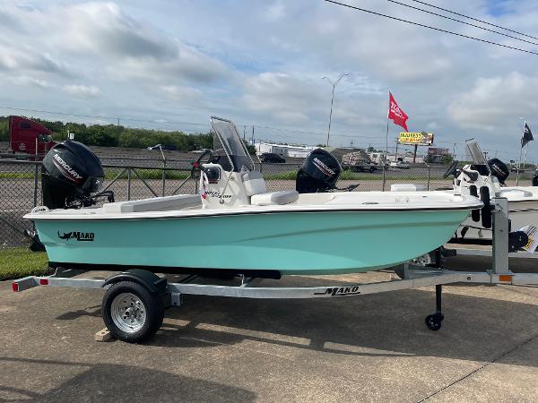 Mako Pro Skiff 13 CC 2025 Mako Pro Skiff 13 CC boat on trailer, parked outdoors.