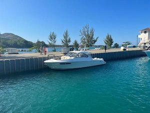Pursuit DC 365 Dual Console 2020 Pursuit DC 365 Dual Console boat docked in a scenic marina.