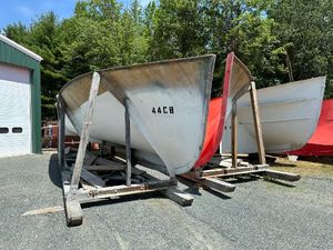Calvin Beal MOLDS 2024 Beal Calvin Beal MOLDS boat hulls on stands, outdoors near a garage.