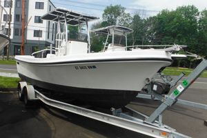 Custom 23 DC BROWN CUSTOM CC 2006 DC 23 DC Brown Custom CC boat on trailer, parked outdoors.