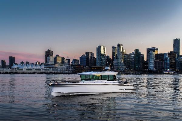 Axopar 37 XC Cross Cabin with Aft Bench 2025 Axopar 37 XC Cross Cabin boat on water with city skyline backdrop.