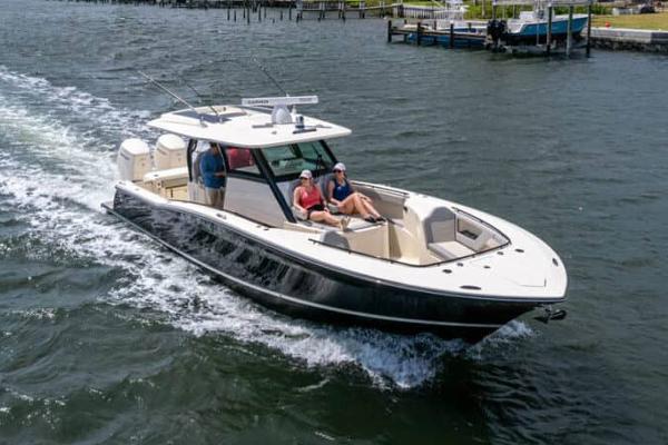 Scout 377 LXF Manufacturer Provided Image: 2025 Scout 377 LXF boat cruising on water with passengers relaxing.