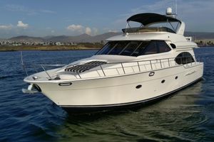 Meridian 580 Pilothouse 2004 Meridian 580 Pilothouse yacht cruising on calm waters with scenic mountain backdrop.