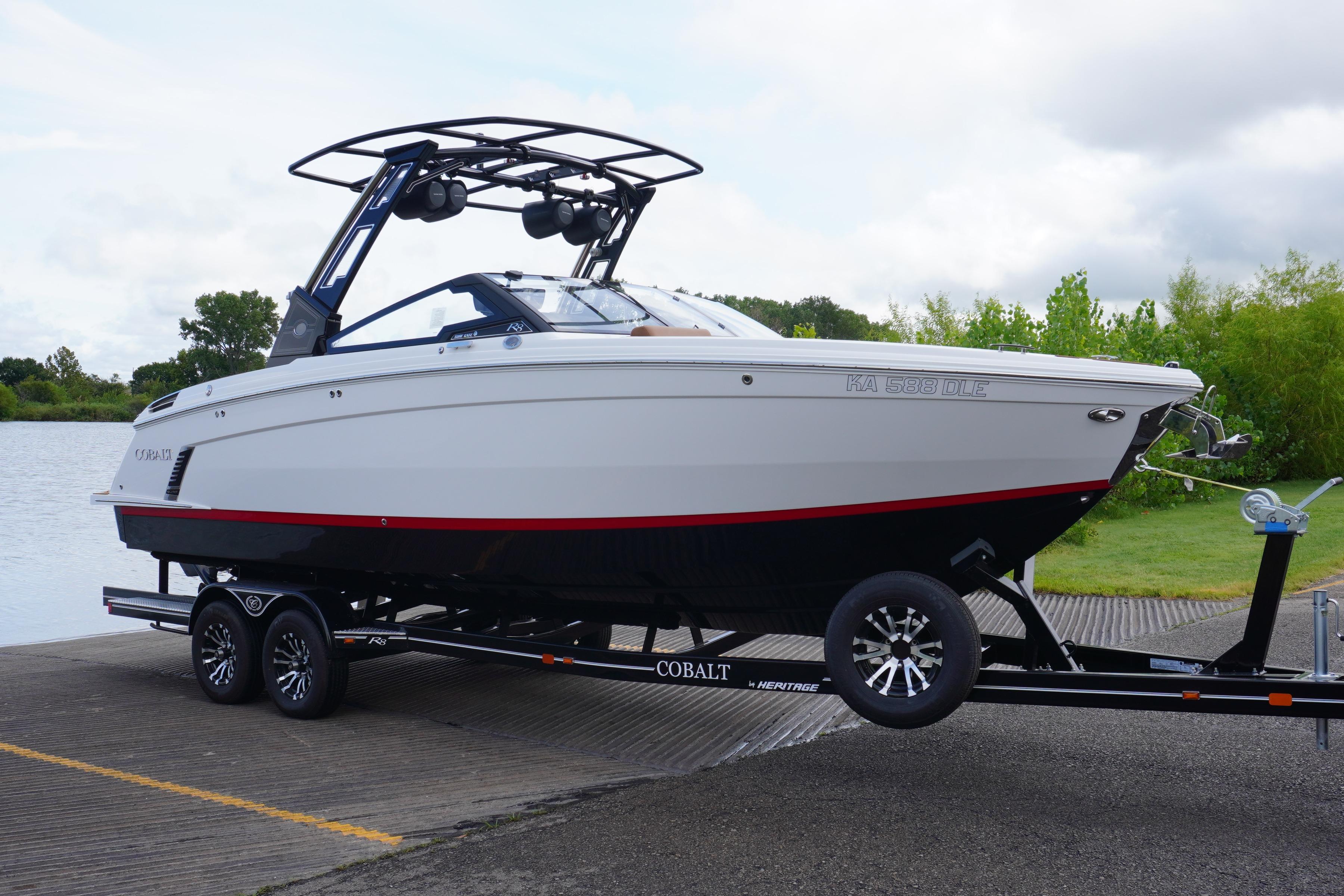 Cobalt R8 Surf 2025 Cobalt R8 Surf boat on trailer by a lake, ready for launch.