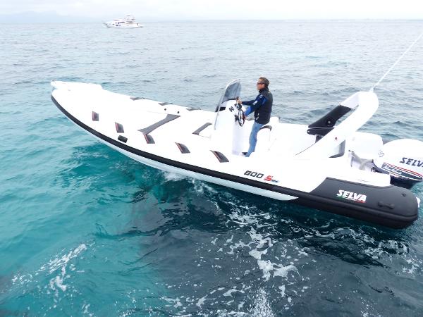 Selva 800 Selva 800 boat from 2016 cruising on open water with a person steering.