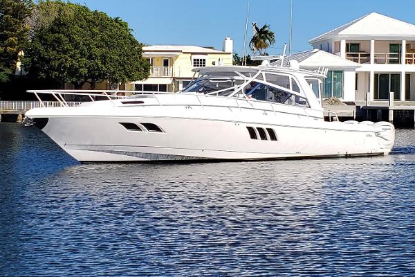 Intrepid 475 Sport Yacht 2019 Intrepid 475 Sport Yacht on calm water near luxury waterfront homes.