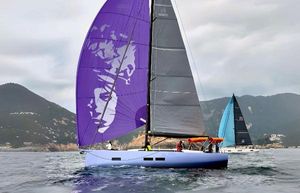 Solaris 44 Sailing yacht Solaris 44, 2021 model, with vibrant purple sail on calm waters.