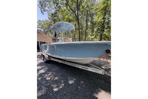 Sea Hunt Ultra 234 2018 Sea Hunt Ultra 234 boat on trailer, parked outdoors under trees.