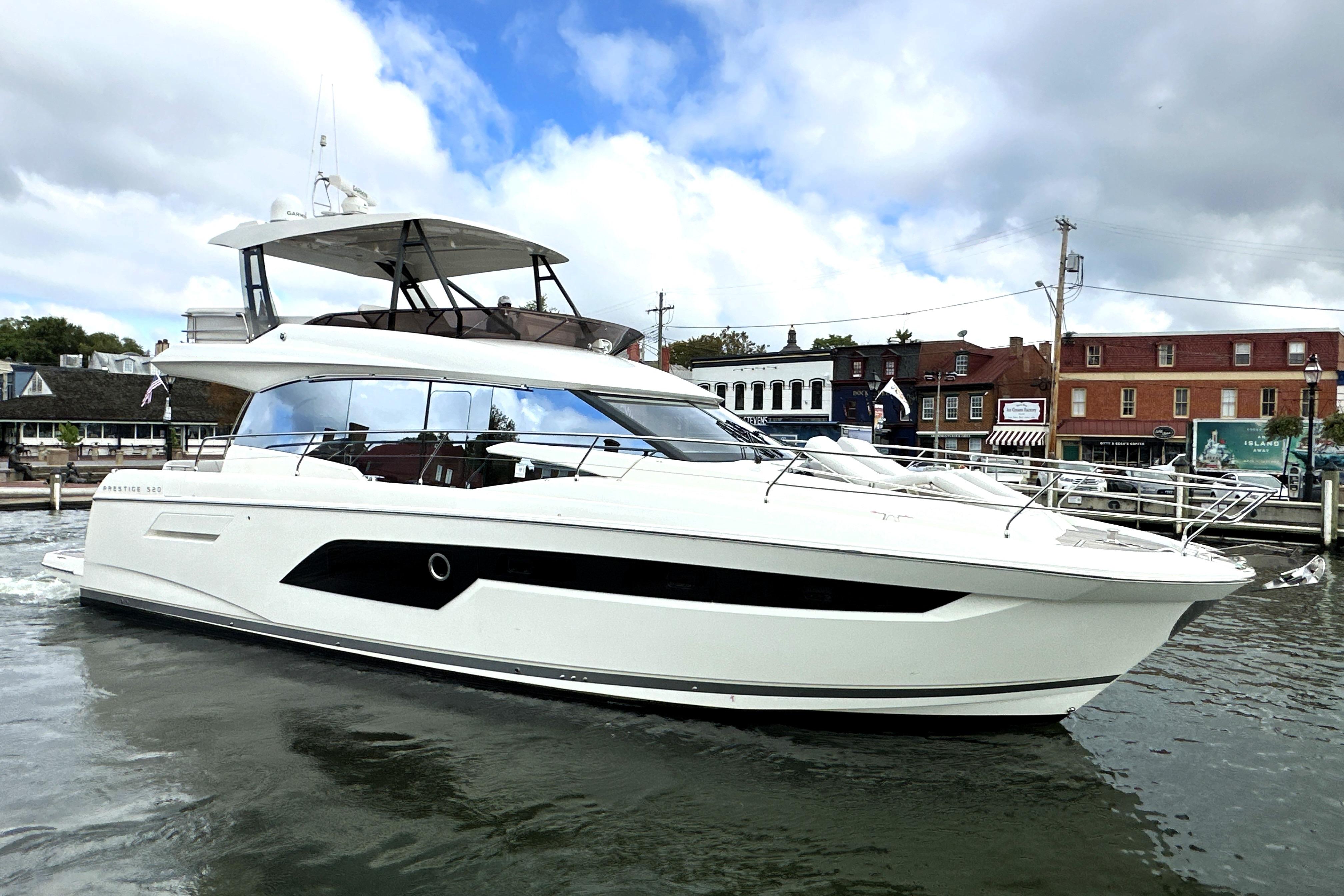 Prestige 520 2023 Prestige 520 yacht docked in a marina, showcasing sleek design and modern features.