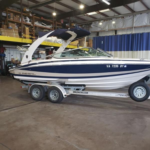 Regal 2100 2014 Regal 2100 boat on trailer in indoor storage facility.