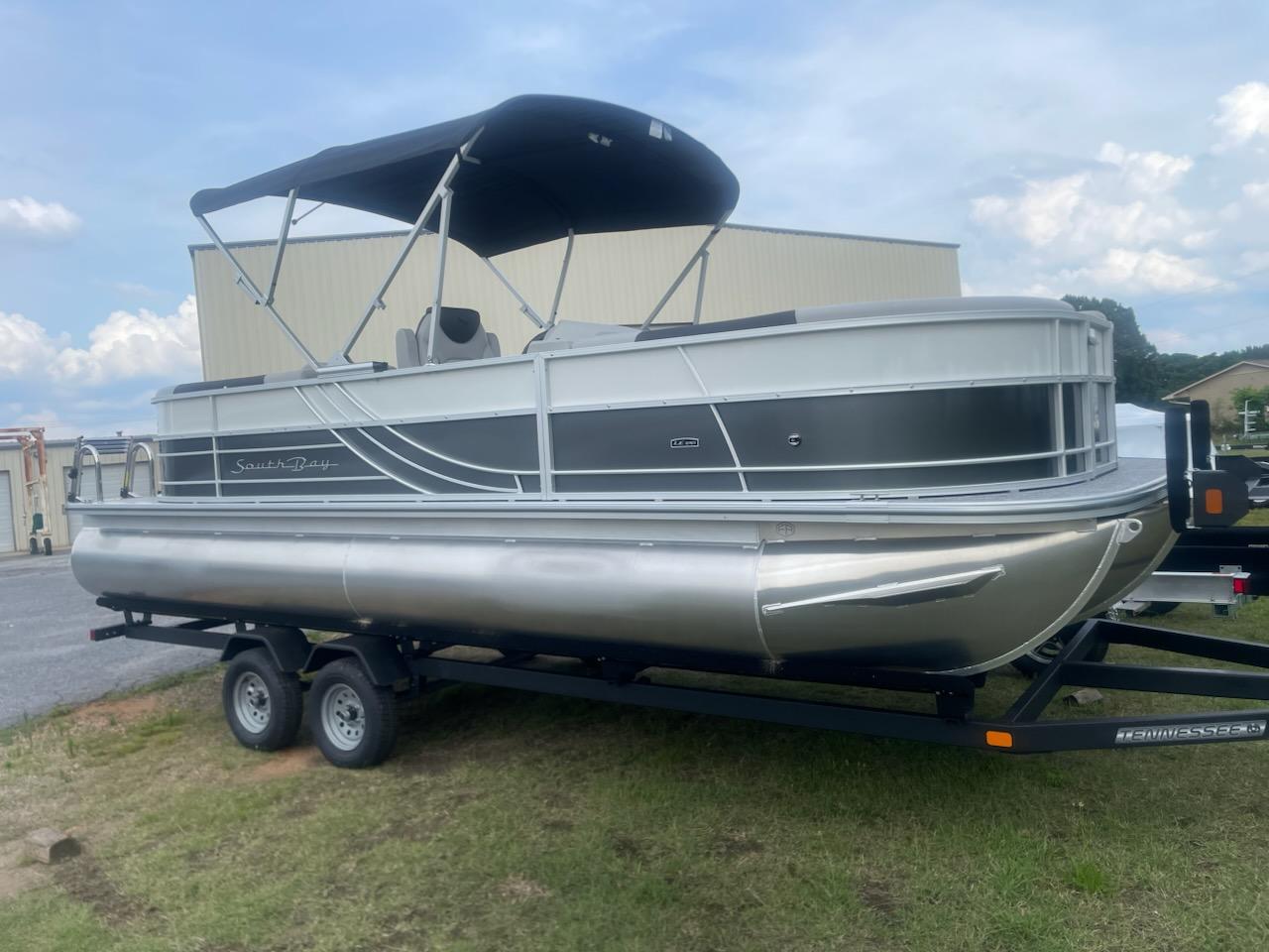 South Bay 224RS LE 2.75 2025 South Bay 224RS LE 2.75 pontoon boat on trailer, parked outdoors.