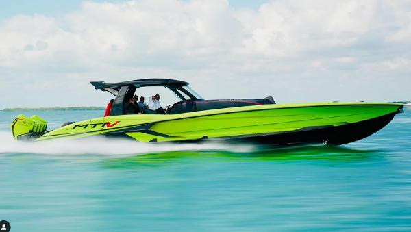 MTI 50V Center Console 2022 MTI 50V Center Console boat speeding on clear blue water.
