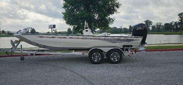 Ranger RB200 2024 Ranger RB200 boat on a trailer by a lake.